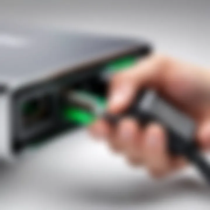 Hand holding Acer Aspire charging cord connector